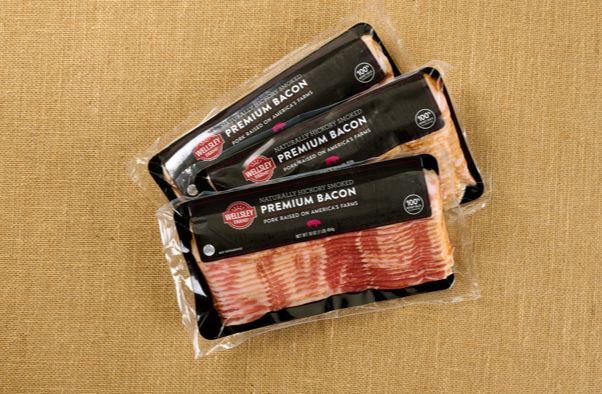 Photo of Weslley Farms bacon packages on a burlap background
