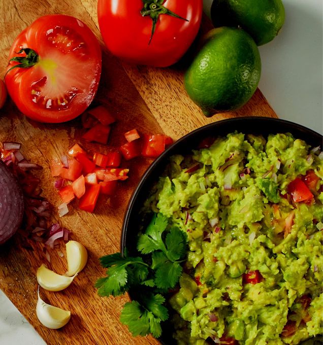 overhead photo of wellsley farms tomatoes, limes, onion and guacamole