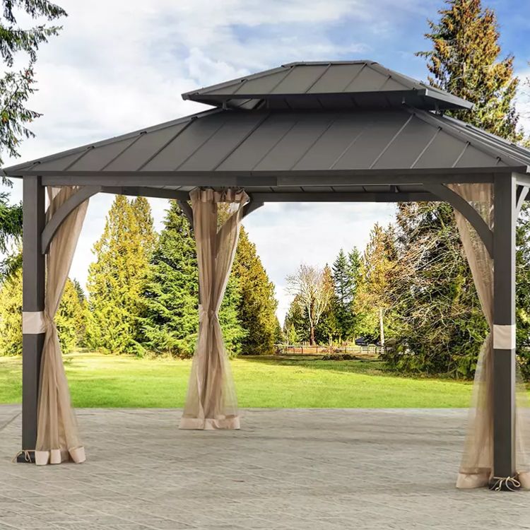 Large umbrella giving shade to wooden outdoor furniture on a sunny day 2023