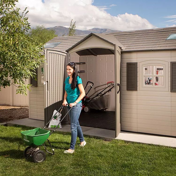 Patio shed with lawn tool storage space, woman seeding grass