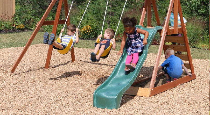 Children playing on a swingset