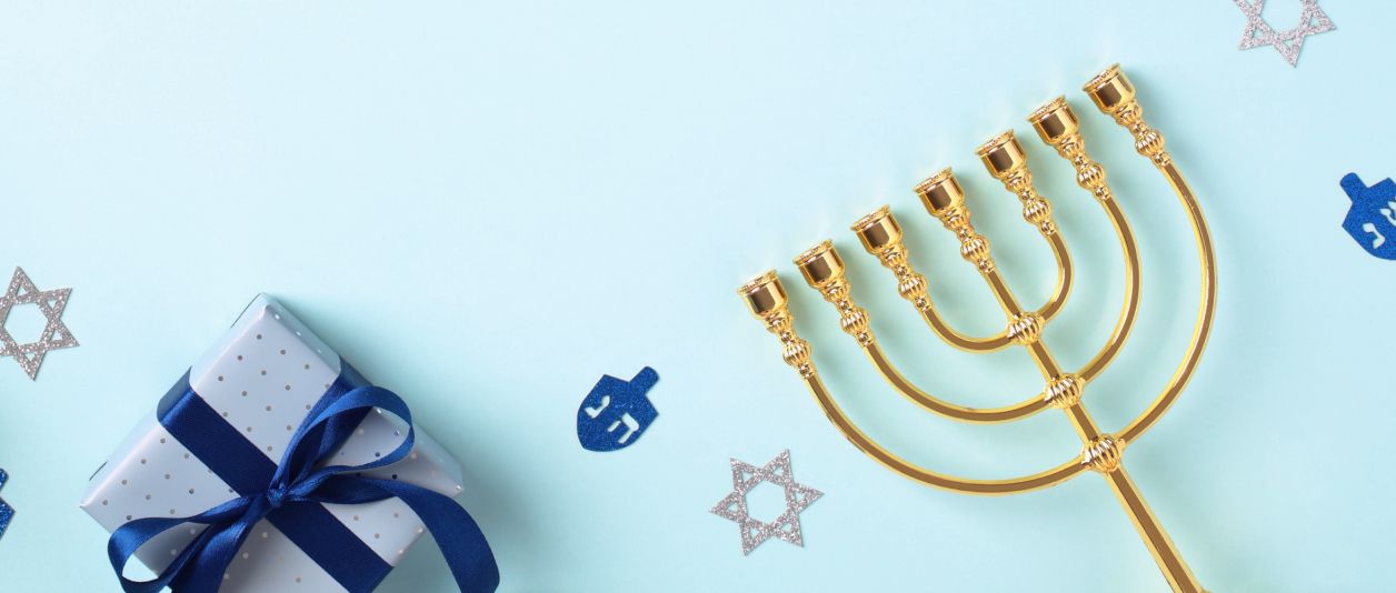 Gifts, a menorah and sparkly cutouts of dreidels and stars