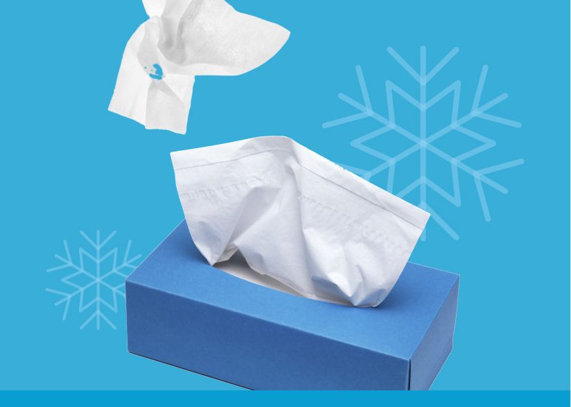 Image: A tissue box with tissues in front of a blue background with snowflakes