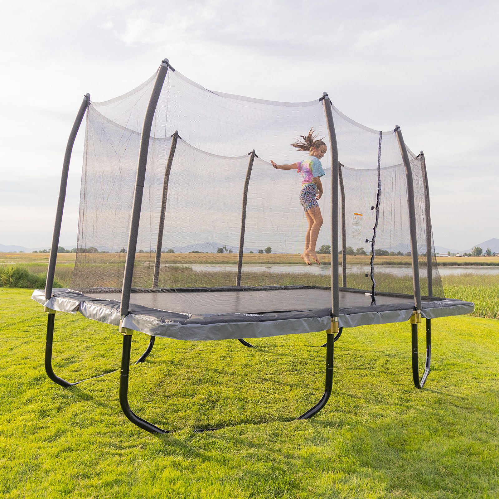 A girl jumping on a Skywalker Rectangle Trampoline.