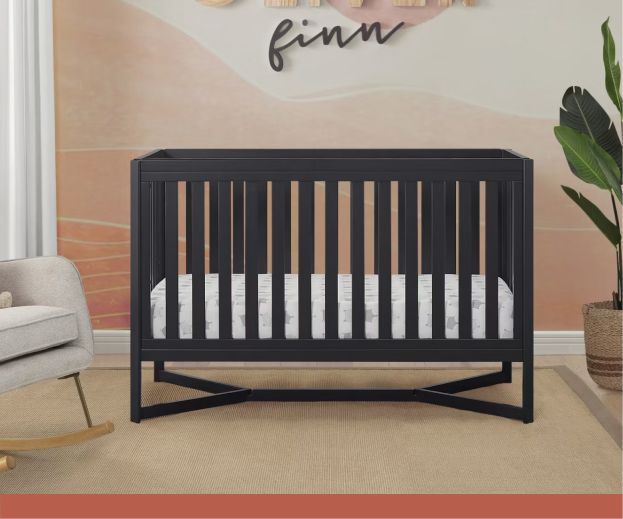 A dark wooden baby crib.
