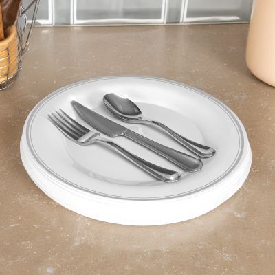 Image: Plate with fork, knife, and spoon on a countertop.