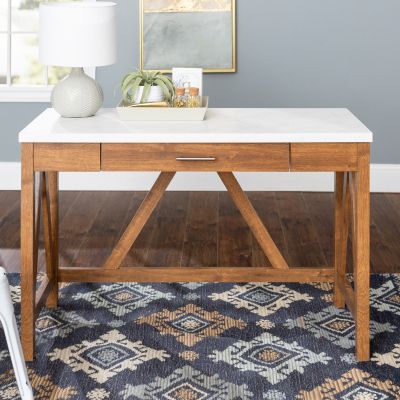 Image: Wooden desk with white top on a blue patterned rug.