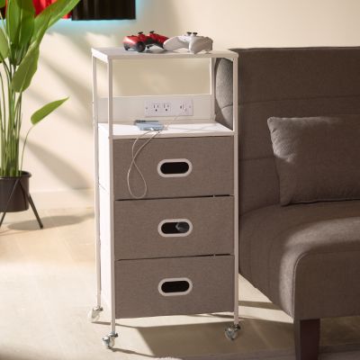 Image: Rolling cart with drawers and outlet panel beside an armchair.
