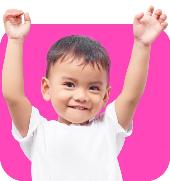 Ages 3 thru 5. A 3-year-old child with his arms raised in the air.