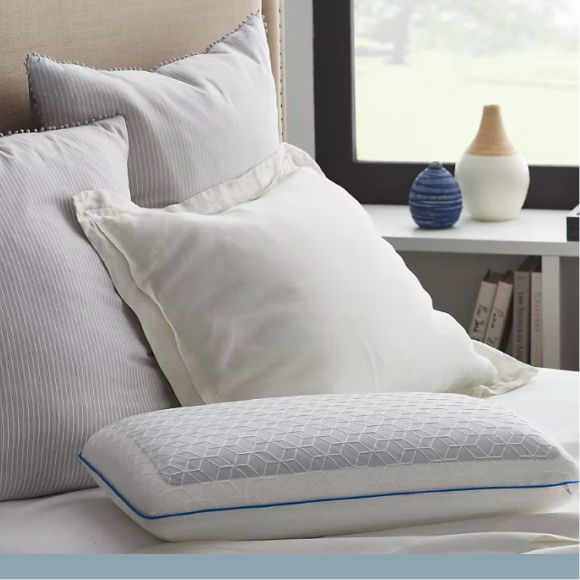 Various colors and kinds of bed pillows on a bed