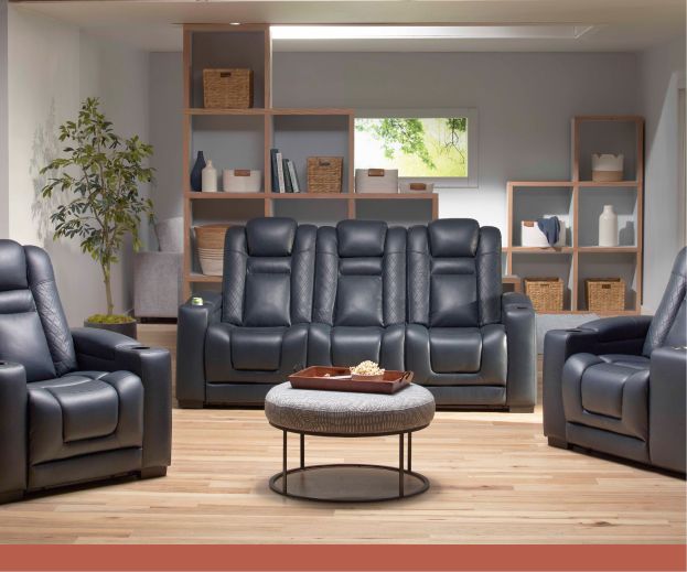 Black leather sofas on either side of a room with a round accent table between them.