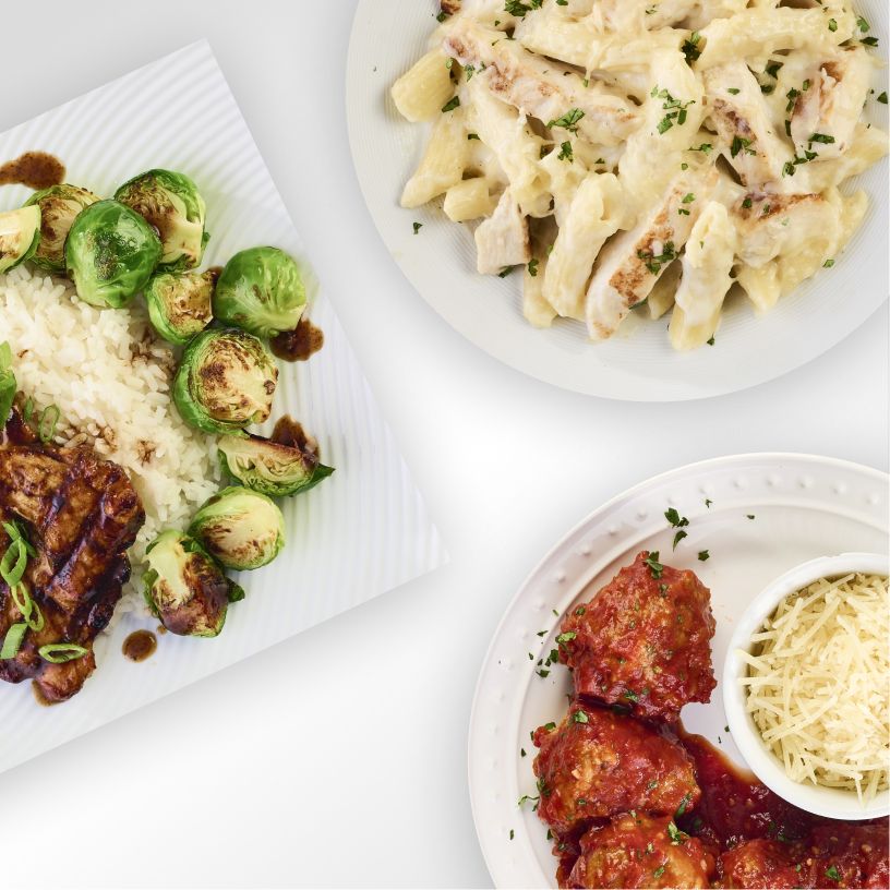 3 plates of food arranged close together on a white table