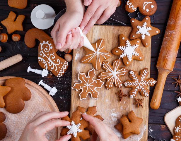 Decorating Christmas cookies on a wood cutting board