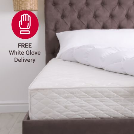 Free white glove delivery - a mattress with comforter pulled back