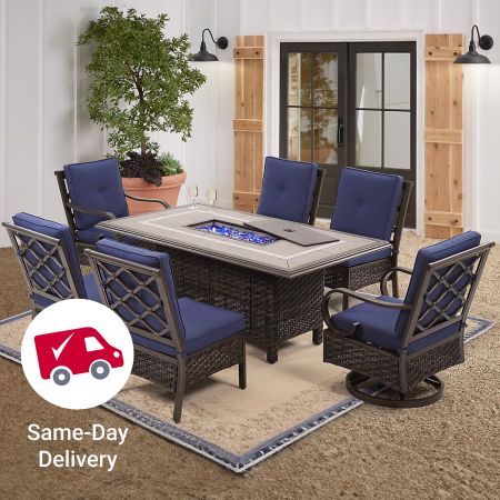 A Berkley Jensen patio table with 6 blue wood and wicker chairs