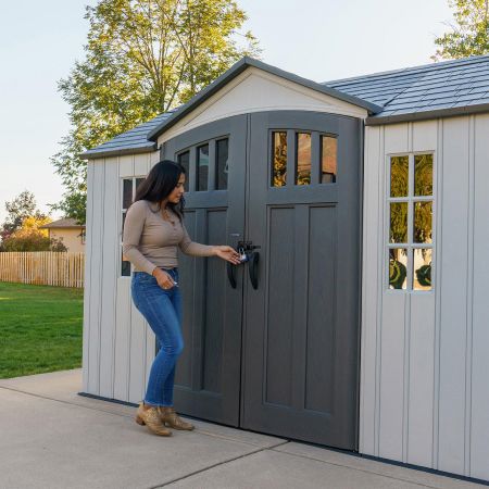 A woman opening her double door garden shed