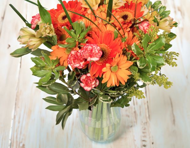 A fall themed flower bouquet on the table.