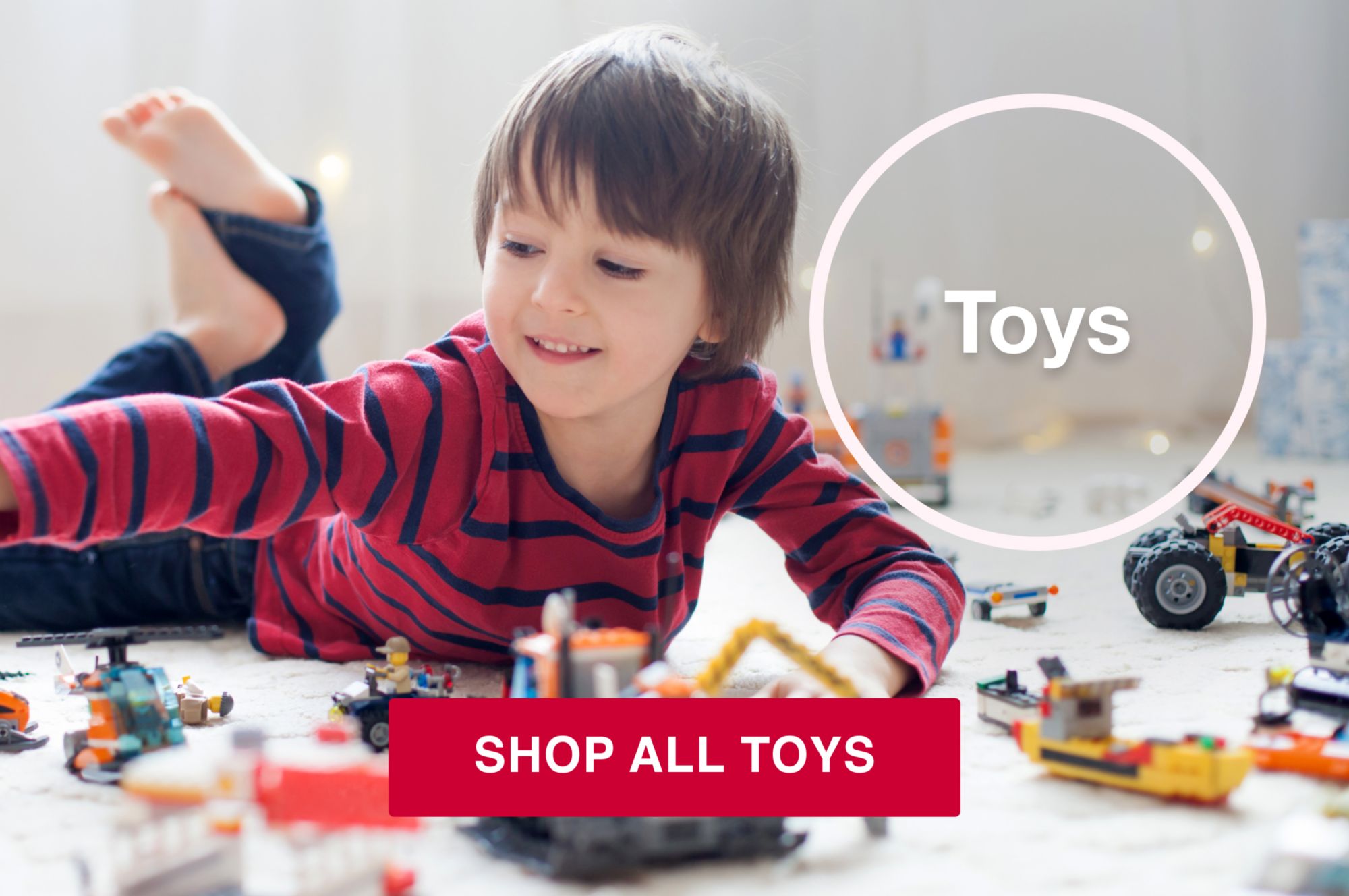 Toys category. A kid playing with legos on the floor